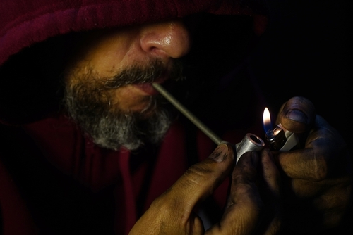 man using heroin pipe