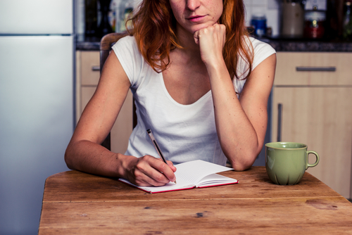 woman writing relapse prevention plan