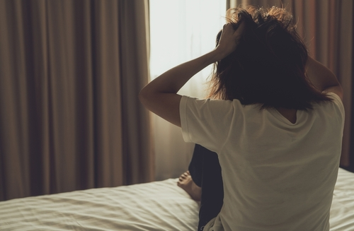 woman pulling hair from stress